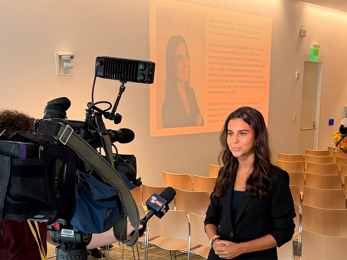 Leyla Tore interviewed by 40/29 News before the evening began, her introduction on the screen behind her.